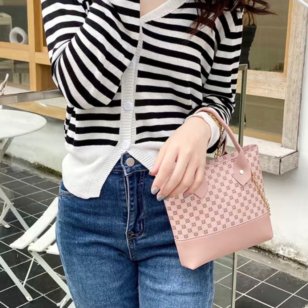 This is a pink purse with a design.